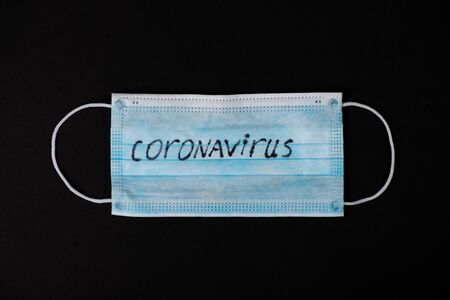 Panic Covid-19 Coronavirus outbreak concept. Coronavirus protective surgical mask on black...