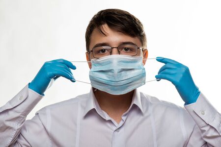 Corona virus covid-19 : Closeup with the face of a young doctor with glasses and wearing medical or...