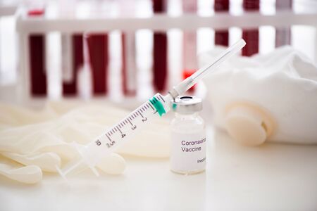 Test tubes with blood sample Covid-19 coronavirus. Vaccine and syringe injection It use for...