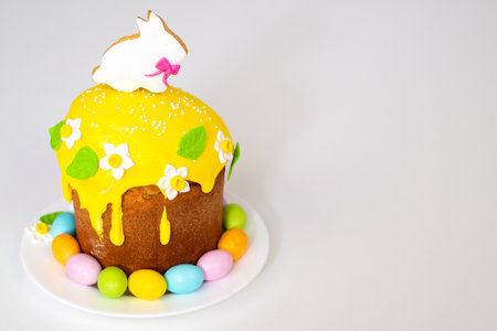 Easter cake with a rabbit and painted eggs on a white background. Religious holiday.の写真素材