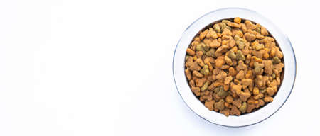 Round metal bowl for pets with dry food. isolated on white background. view from above. Full plate...