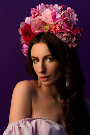 Portrait of an attractive young Ukrainian woman wearing a beautiful wreath of pink roses. Headdress for a girl. Concept wedding style or beauty salon and skin care. High quality photoの写真素材