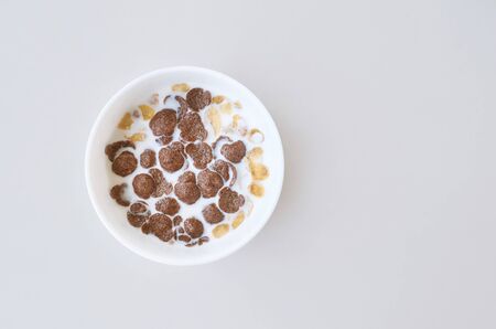 Cereal corn flakes with milk in bowl