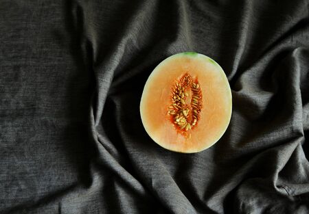 Cantaloupe Melon on clothing background, fruit healthy food, space for textの写真素材