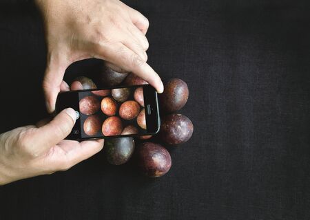 Photography of smartphone with Passion Fruit from farm, photo top viewの写真素材