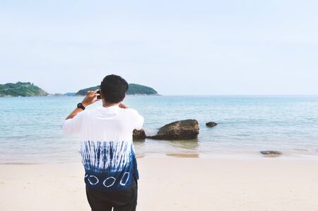 Man take a photo sea view, travel trip concept