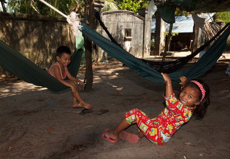 SIHANOUKVILLE, CAMBODIA - NOVEMBER 18, 2014 Unidentified poor cambodian children playing in hammocks.のeditorial素材