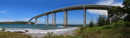 Tropical seascape with a high concrete bridge to an islandの写真素材