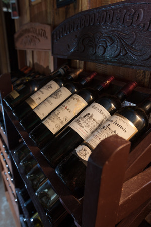 SIHANOUKVILLE, CAMBODIA - MARCH 06, 2015: European traditional shelves with wine bottles in Otres beach bar in Sihanoukville, Cambodia. Closeup photo with shallow DOF のeditorial素材