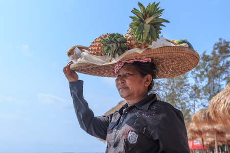 SIHANOUKVILLE, CAMBODIA -  MARCH 03, 2015: unidentified woman selling fresh fruit at the shorelineのeditorial素材