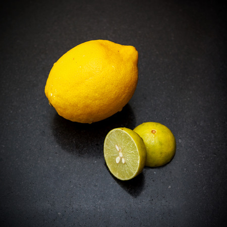 Limes and lemon on black granite, shallow  DOF photo view 1の写真素材