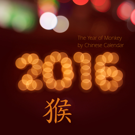 new year greeting card made of colorful bokeh digits in shape of 2016 on red background with copy space. Chinese  hieroglyph for monkeyの写真素材