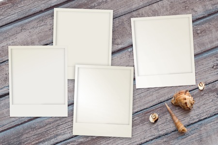 Snapshots templates arranged on rustic wooden background with seashells around with copy space, top viewの写真素材