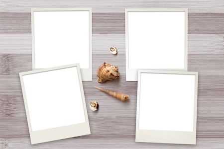 Snapshots templates arranged on rustic wooden background with seashells around with copy space, top viewの写真素材
