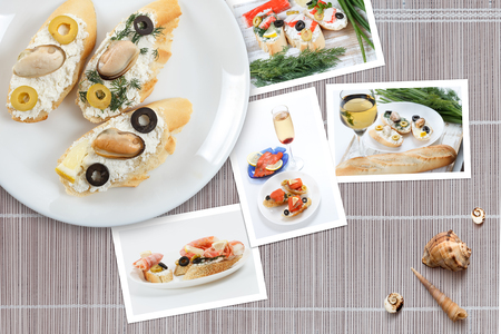 Beautiful snapshots of various italian sandwiches with seafood arranged on rustic wooden background with plates with food and seashells, with copy space, horizontal top view.の写真素材