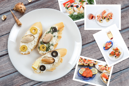 Beautiful snapshots of various italian sandwiches with seafood arranged on rustic wooden background with plates with food and seashells, with copy space, horizontal top view.の写真素材