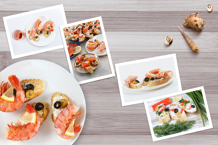 Beautiful snapshots of various italian sandwiches with seafood arranged on rustic wooden background with plates with food and seashells, with copy space, horizontal top view.の写真素材