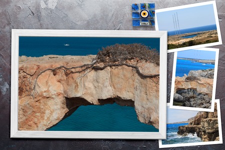 Beautiful snapshots of various Cyprus landscapes in wooden frames arranged on rustic background, with copy space, horizontal top view.の写真素材
