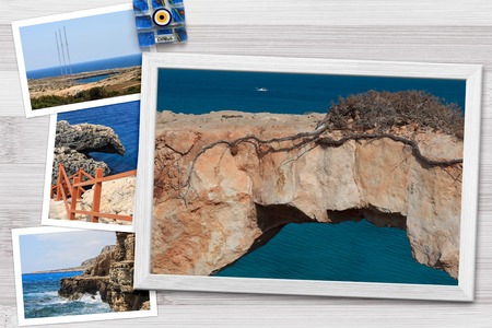 Beautiful snapshots of various Cyprus landscapes in wooden frames arranged on rustic background, with copy space, horizontal top view.の写真素材