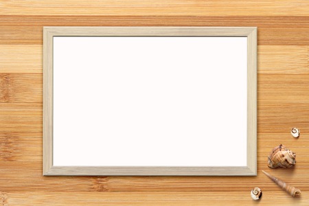 Mock up of blank poster in wooden frame on rustic wooden background with seashells