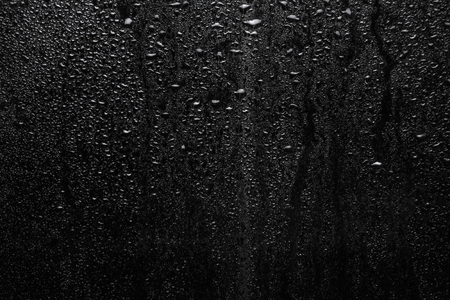 Part of series. Background photo of rain drops on dark glass, different size: small medium and large, horizontal viewの写真素材
