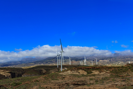 TENERIFE, SPAIN - NOVEMBER 2018: Group of windmills for electric power production in front of the mountains in Tenerife, Spainのeditorial素材