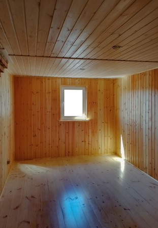Empty new living room in a wooden countryhouse. Wooden walls and parquet flooringの写真素材