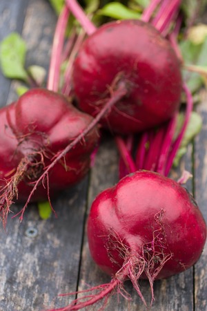 Three beetroot on the wooden table, close-upの写真素材