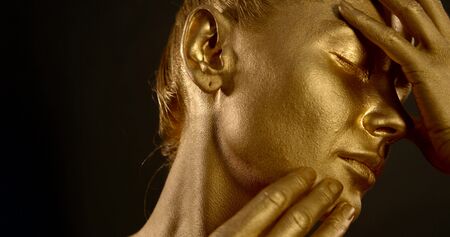 Close-up portrait of a gentle naked girl, she is in the Studio on a black background, she has a...