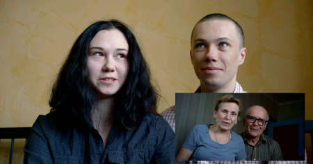 remote parents with children communicate online in a virtual app using a webcam, enjoying lifestyle...
