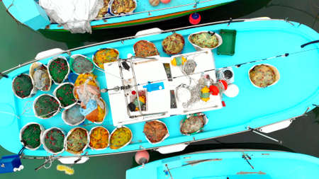 Aerial video of a traditional wooden fishing boat in the Old port of Cyprus. On top of the...
