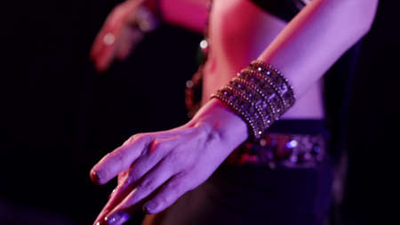 belly dancer is moving hips, closeup view on sexy female body, dancing in darknessの写真素材