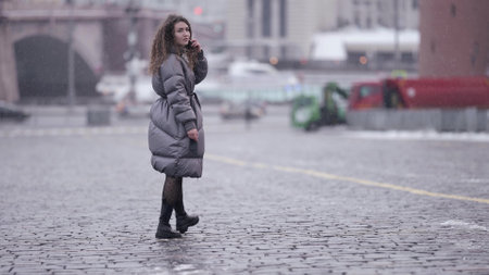female student is walking in big city at winter day, megapolis and urban landscapeの写真素材
