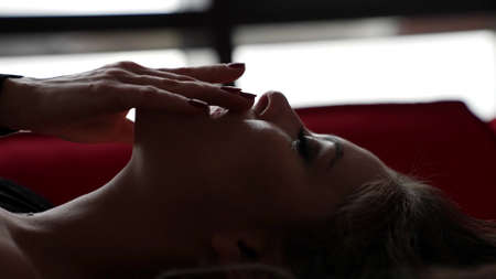 excited woman is stroking her face during sex or preliminary caress, self-pleasure, closeup portraitの写真素材