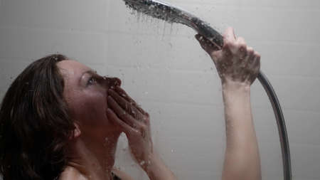 lady is relaxing in shower after working day, washing her body and resting, portrait of woman
