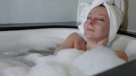 pleasure and self-gratification, adult lady is laying in bubble bath at home at weekend