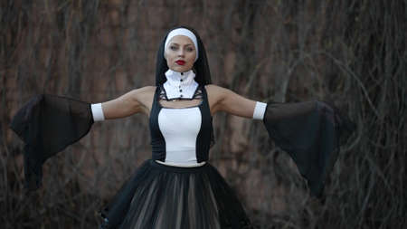 extravagant   nun is posing for camera outdoors, medium portraitの写真素材