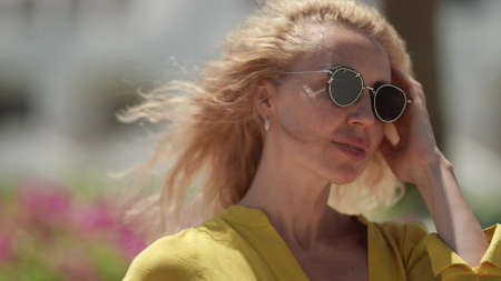 pretty middle aged woman with fashion sunglasses in summer, portrait shot