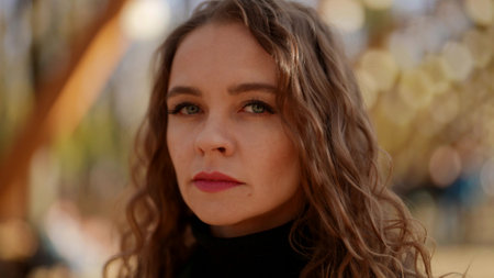 portrait of sad and frustrated woman on street in autumn day, closeup of face