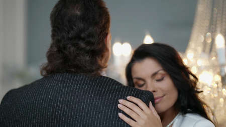 romantic date or wedding, happy woman is snuggling to her beloved man during danceの写真素材