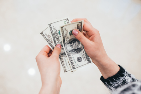 The girl keeps the hands in dollarsの写真素材