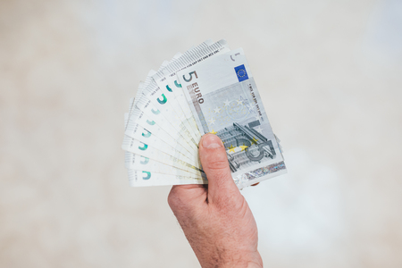 A man holds dollars in his handsの写真素材