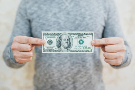 A man with dollars in her hands. Isolated on white backgroundの写真素材