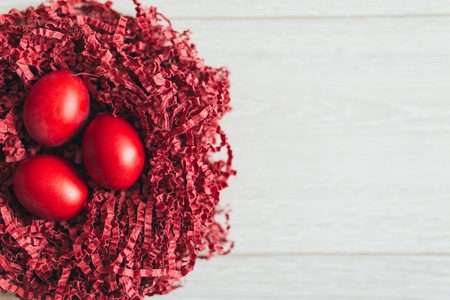 Red Easter eggs in the table holidaysの写真素材
