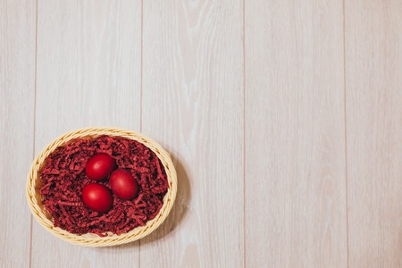 Colorful easter egg in the nest on wood background with space backgroundの写真素材