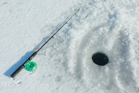 winter fishing, fisherman snow frozen ice sportの写真素材
