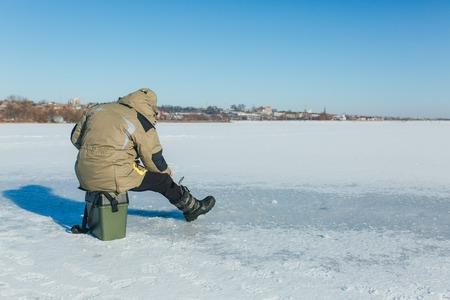 Ice fisherman on winter lake landscape natureの写真素材