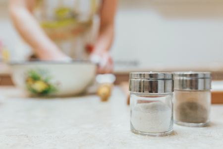 Making dough by female hands at bakery cakesの写真素材