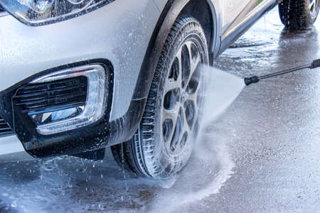 Grodno, Belarus - 01/06/2020: Washing a silver Renault Kaptur car on the first day of summer. The...
