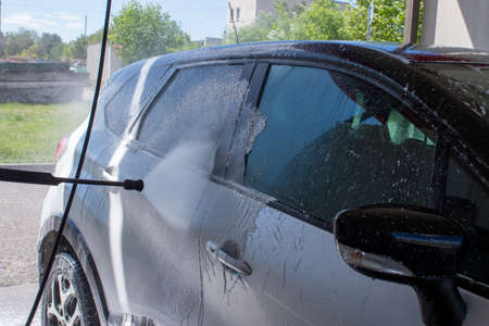 Grodno, Belarus - 01/06/2020: Washing a silver Renault Kaptur car on the first day of summer. The output from the isolation of coronavirusのeditorial素材
